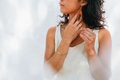 Beaded fringe earrings with a simple design modeled on a woman.