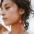 woman wearing fair trade earrings
