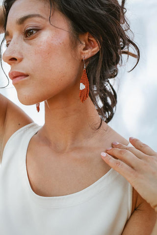 woman wearing fair trade earrings