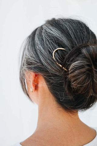 matte brass pin in woman's hair