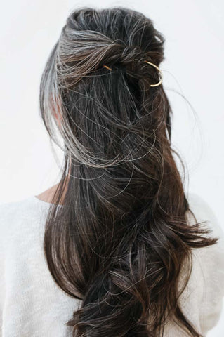 matte brass pin in woman's hair