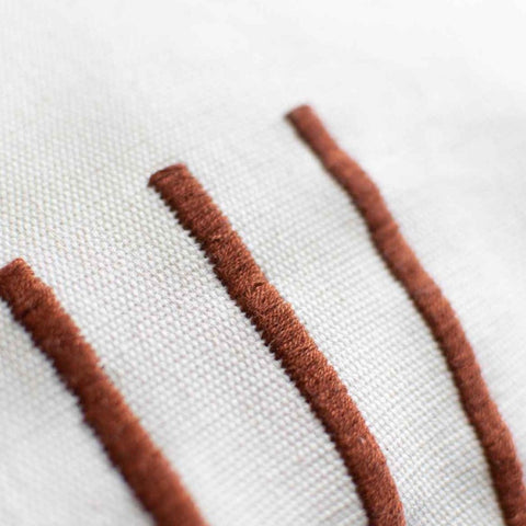 fair trade textural details of hand woven pillow in cinnamon stripes