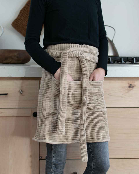 woman wear a waffle fabric half apron in kitchen
