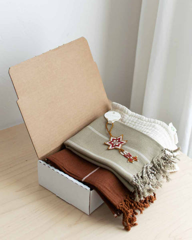 simple holiday gift box with fair trade towels and washcloths and ornament