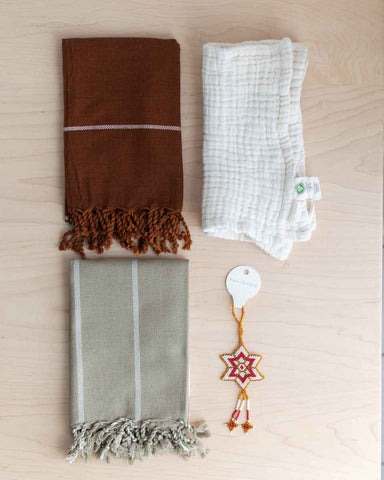 simple holiday gift box with fair trade towels and washcloths and ornament