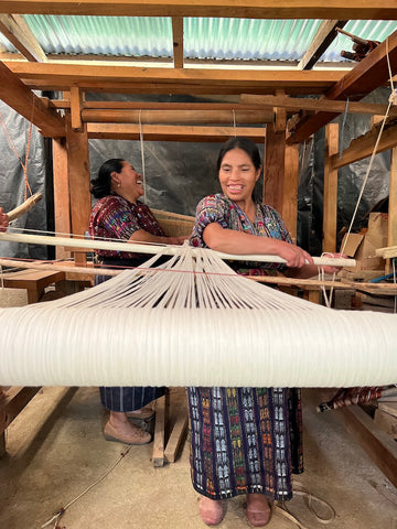 Mayan women warping a pedal loom together